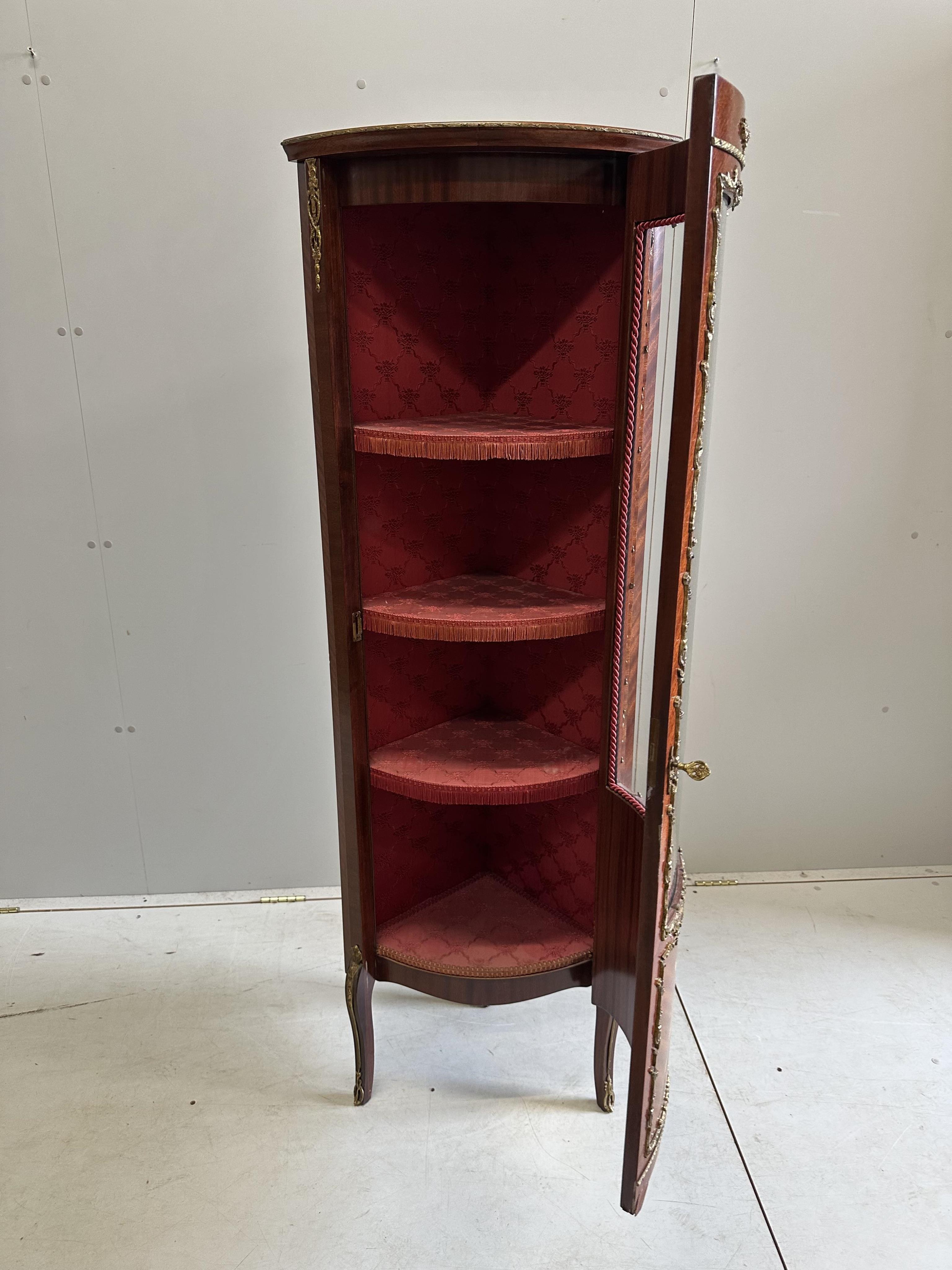 A Louis XVI style marquetry inlaid and gilt metal mounted mahogany corner cabinet, width 52cm, depth 38cm, height 157cm. Condition - good